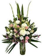 Bouquet of flowers in a vase with 'Coastal Blooms' branding on a white background